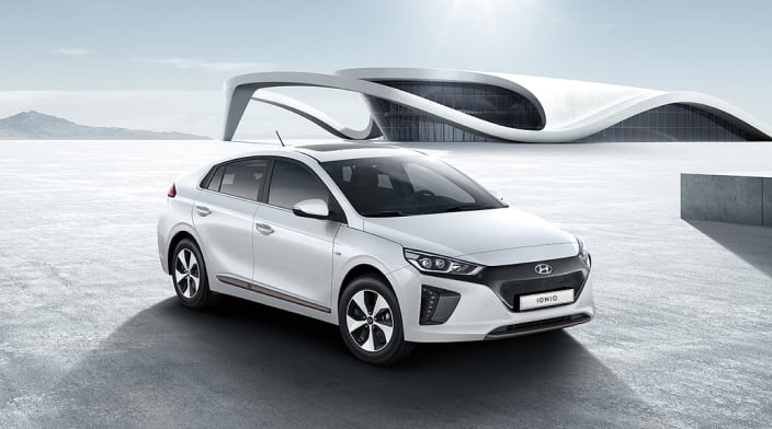 Side front view of white Ioniq Electric parked outside